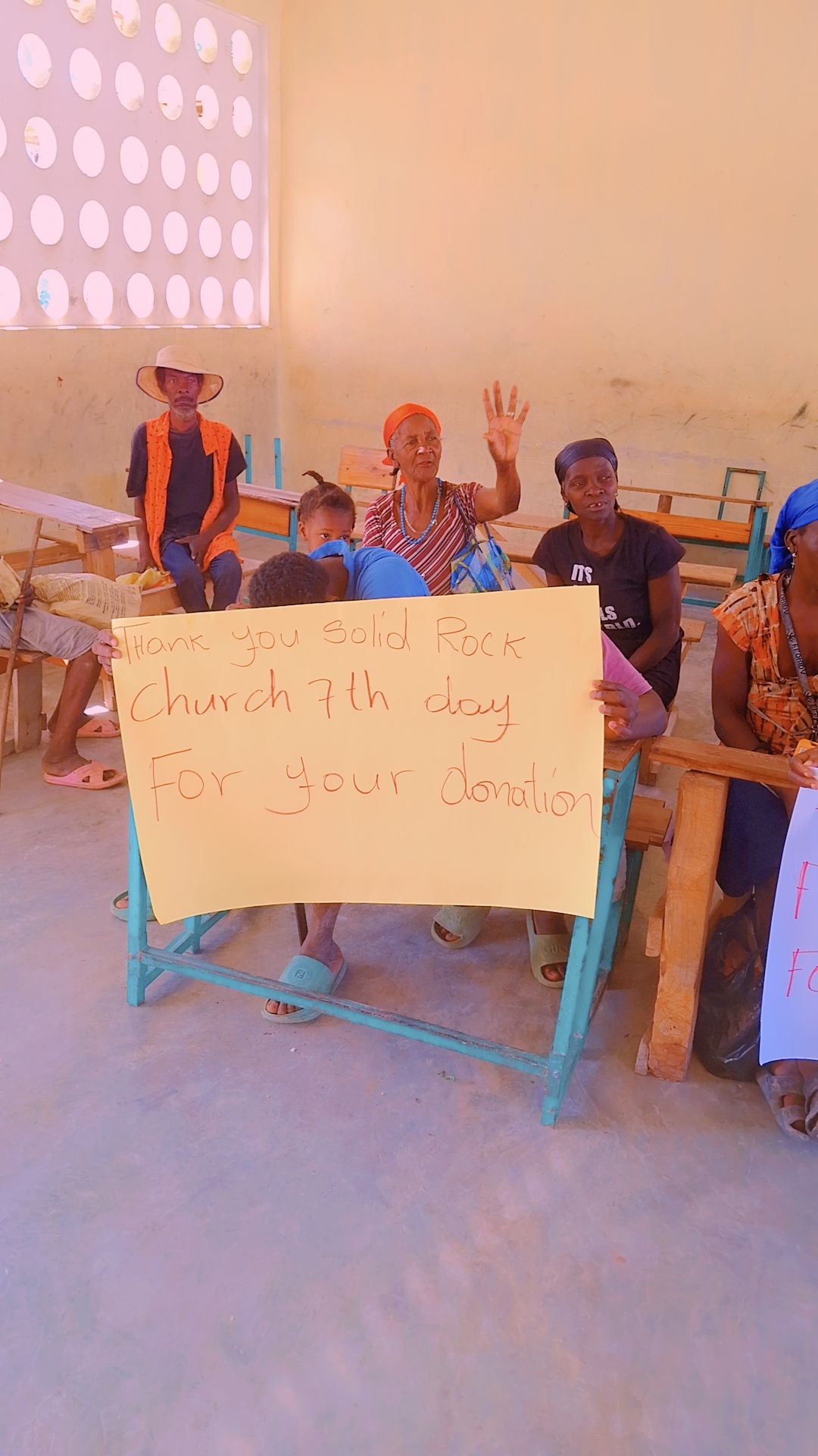Community members expressing thanks for donations from Solid Rock Church